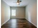 Bedroom featuring neutral paint and wood-look floors; ceiling fan and window visible at 1849 Wanda Way, Ellenwood, GA 30294