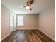 This bedroom features hardwood floors, a ceiling fan, and a window with a blind at 1849 Wanda Way, Ellenwood, GA 30294