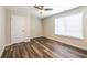 This bedroom features hardwood floors, a ceiling fan, and a window with a blind at 1849 Wanda Way, Ellenwood, GA 30294