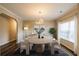 Formal dining room with modern decor, elegant lighting, and ample natural light at 1849 Wanda Way, Ellenwood, GA 30294