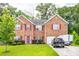 Charming two-story brick home with a well-manicured lawn and colorful red window shutters at 1849 Wanda Way, Ellenwood, GA 30294