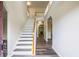 Bright foyer featuring hardwood floors and a staircase with white risers and wood railing at 1849 Wanda Way, Ellenwood, GA 30294