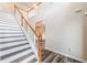 Bright foyer featuring hardwood floors and a staircase with white risers and wood railing at 1849 Wanda Way, Ellenwood, GA 30294