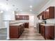 Open-concept kitchen with dark wood cabinets, granite countertops, and stainless steel appliances at 1849 Wanda Way, Ellenwood, GA 30294