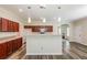 Bright kitchen with a large center island, dark wood cabinets, and modern pendant lighting at 1849 Wanda Way, Ellenwood, GA 30294