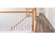 Upstairs hallway features a white wooden staircase and wood-look floors at 1849 Wanda Way, Ellenwood, GA 30294