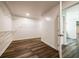 Walk-in closet with white walls, wire shelving, wood floors, and an open doorway at 1849 Wanda Way, Ellenwood, GA 30294
