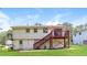 Exterior view of a two-story house with a wooden deck and a large, grassy yard at 4133 Conley Circle Cir, Conley, GA 30288