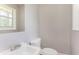 Bright bathroom with a single sink vanity and toilet; window provides natural light at 4133 Conley Circle Cir, Conley, GA 30288