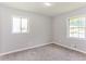 Carpeted bedroom with two windows offering natural light and neutral paint at 4133 Conley Circle Cir, Conley, GA 30288