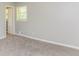 Bright bedroom with neutral paint, carpeting, a window, and a view to the hallway at 4133 Conley Circle Cir, Conley, GA 30288