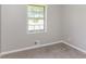 This bedroom features soft carpet, a window for light, and fresh neutral walls at 4133 Conley Circle Cir, Conley, GA 30288