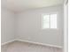 This bedroom offers neutral walls, carpeted floors, and natural light from a window at 4133 Conley Circle Cir, Conley, GA 30288