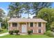 Charming brick home features a well-maintained lawn and classic architectural details at 4133 Conley Circle Cir, Conley, GA 30288