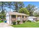 Well-manicured lawn complements the traditional two-story brick home and surrounding landscape at 4133 Conley Circle Cir, Conley, GA 30288