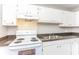 Bright kitchen boasts granite countertops, updated appliances, and white cabinets at 4133 Conley Circle Cir, Conley, GA 30288