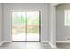 Bright living area showcases hardwood floors and sliding doors to the outdoor space at 4133 Conley Circle Cir, Conley, GA 30288
