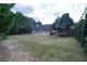Aerial view of the backyard and back exterior of the home surrounded by trees at 1200 Martins Chapel Se Ln, Lawrenceville, GA 30045