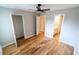Bedroom featuring hardwood floors, a ceiling fan, and access to the closet and bathroom at 1200 Martins Chapel Se Ln, Lawrenceville, GA 30045