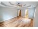 Bedroom featuring hardwood floors, a trey ceiling with fan, and access to the bathroom at 1200 Martins Chapel Se Ln, Lawrenceville, GA 30045