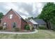 Charming single-Gathering home with brick exterior, manicured lawn and a welcoming walkway at 1200 Martins Chapel Se Ln, Lawrenceville, GA 30045