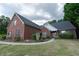 Charming single-Gathering home with brick exterior, manicured lawn and a welcoming walkway at 1200 Martins Chapel Se Ln, Lawrenceville, GA 30045