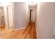Hallway with hardwood floors, neutral paint, and doors leading to other rooms at 1200 Martins Chapel Se Ln, Lawrenceville, GA 30045