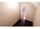 Hallway with wood-look flooring and open doorway to another room at 1200 Martins Chapel Se Ln, Lawrenceville, GA 30045