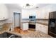 Close up of updated kitchen boasting stainless steel appliances and granite countertops at 1200 Martins Chapel Se Ln, Lawrenceville, GA 30045