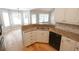 Bright kitchen features granite counters, white cabinetry, stainless steel sink and wood floor at 1200 Martins Chapel Se Ln, Lawrenceville, GA 30045