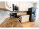 Kitchen features granite countertops, stainless steel appliances, and white cabinetry at 1200 Martins Chapel Se Ln, Lawrenceville, GA 30045