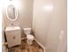 Cozy powder room featuring a white vanity, toilet, and neutral decor at 1200 Martins Chapel Se Ln, Lawrenceville, GA 30045