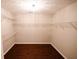 Empty walk-in closet with dark wood floors and adjustable wire shelving at 1200 Martins Chapel Se Ln, Lawrenceville, GA 30045