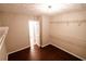 Spacious walk-in closet featuring custom shelving, hardwood floors, and neutral paint at 1200 Martins Chapel Se Ln, Lawrenceville, GA 30045