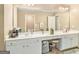 Bathroom with a vanity featuring double sinks and a coffee machine at 1209 Persimmon Way, Mcdonough, GA 30252