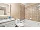 Bright bathroom features granite countertop vanity and a tiled shower and soaking tub combination at 1209 Persimmon Way, Mcdonough, GA 30252