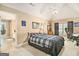 Spacious bedroom featuring a bed with a plaid comforter and a well-lit workspace by the windows at 1209 Persimmon Way, Mcdonough, GA 30252