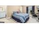 Bright bedroom features a cozy bed, an adjacent bathroom, and a comfortable workspace with a computer at 1209 Persimmon Way, Mcdonough, GA 30252