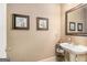 Cozy powder room featuring decorative wall art, pedestal sink, and classic fixtures at 1209 Persimmon Way, Mcdonough, GA 30252