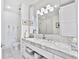 Bright bathroom with marble countertops, double sinks, a large mirror, and under-cabinet storage at 1820 Peachtree Nw St # 1008, Atlanta, GA 30309