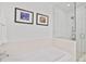 Bright bathroom features a soaking tub with a glass-enclosed shower and mosaic tile at 1820 Peachtree Nw St # 1008, Atlanta, GA 30309