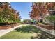 Scenic community green space enhanced with shade trees, benches, and brick planters at 1820 Peachtree Nw St # 1008, Atlanta, GA 30309