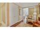 Charming hallway featuring wallpaper, hardwood floors, a patterned armchair, and a glimpse into the living area at 1820 Peachtree Nw St # 1008, Atlanta, GA 30309