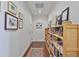Inviting hallway with hardwood floors, gallery wall, and built-in bookshelves, creating a warm and stylish entryway at 1820 Peachtree Nw St # 1008, Atlanta, GA 30309
