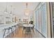 Open concept kitchen and dining area with white cabinets, stainless steel appliances, and modern pendant lighting at 1820 Peachtree Nw St # 1008, Atlanta, GA 30309