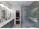 Modern bathroom showcasing a glass shower, dual sink vanity, and view to main bedroom at 3021 Stone Bridge Sw Trl, Conyers, GA 30094