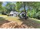 Charming one-story home with a two-car garage surrounded by lush greenery and trees at 3021 Stone Bridge Sw Trl, Conyers, GA 30094