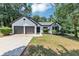 Inviting one-story home with a two-car garage and beautiful landscaping at 3021 Stone Bridge Sw Trl, Conyers, GA 30094