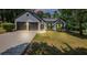 Beautifully landscaped one-story home with a two-car garage and a well-manicured lawn at 3021 Stone Bridge Sw Trl, Conyers, GA 30094