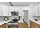 Modern kitchen featuring stainless steel appliances, two-tone cabinets, and quartz countertops at 3021 Stone Bridge Sw Trl, Conyers, GA 30094